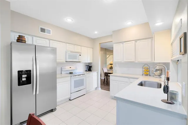 a kitchen with a refrigerator a sink and dishwasher