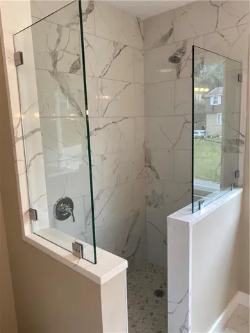 a bathroom with a sink a mirror and shower