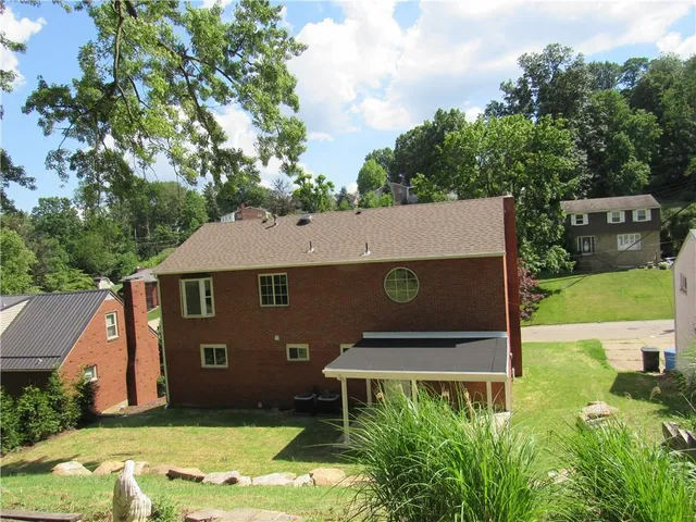 an aerial view of a house with yard