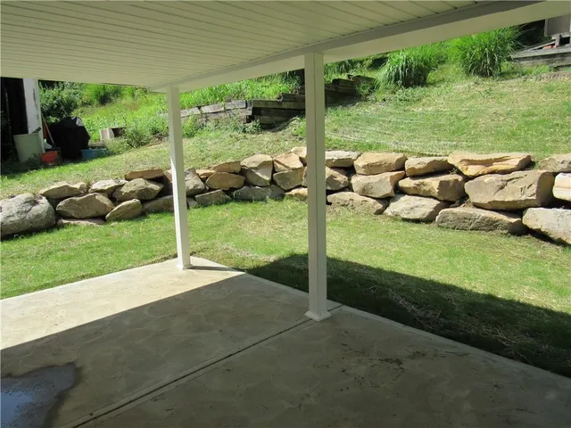 a view of a porch with furniture and yard