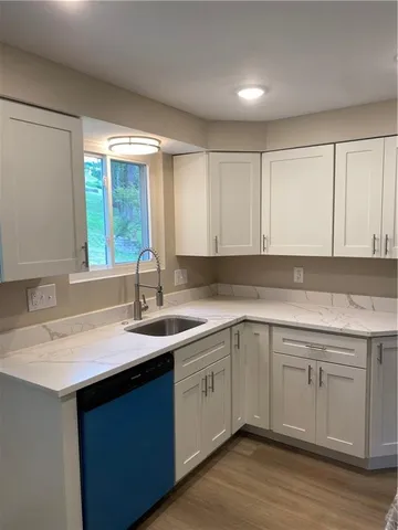 a kitchen with a sink cabinets and window