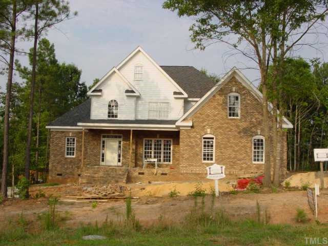 Here's the front elevation of this lovely brick custom home. It won't be long until the landscaping is complete! Exterior Front