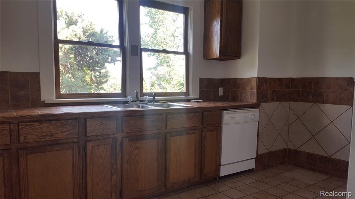 130 Mason Road Howell, MI 48843 - Photo 8 of 33 Gallery kitchen with dishwasher. Tiled counter tops.