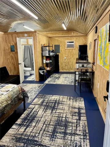 a large hall with wooden floor and furniture