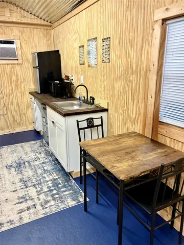 a kitchen with stainless steel appliances microwave stove and wooden floor