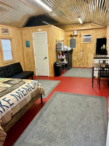 a bedroom with a bed and flat screen tv