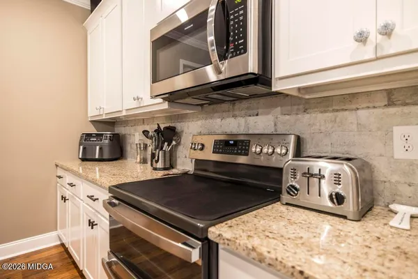 a kitchen with a stove and a microwave