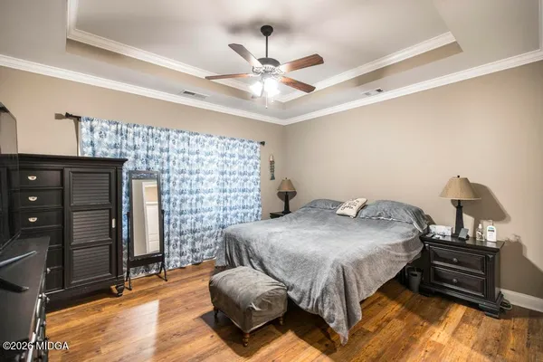 a bedroom with furniture and flat screen tv