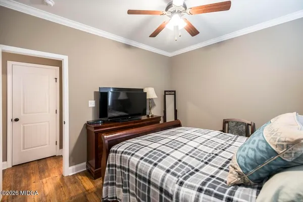 a view of a hallway with wooden floor and entryway