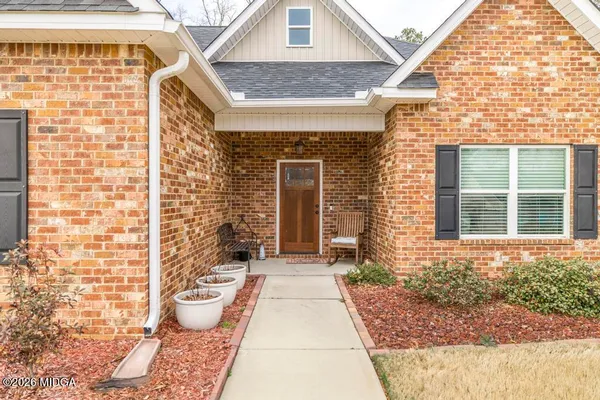 a view of a brick house with outdoor space