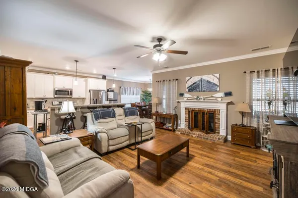 a living room with furniture a fireplace and a flat screen tv