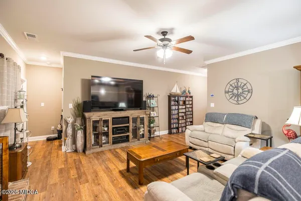 a living room with furniture and a flat screen tv