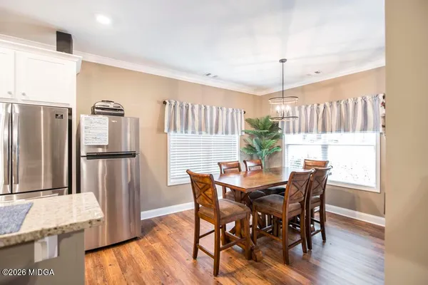 a view of a dining room with furniture window and wooden floor
