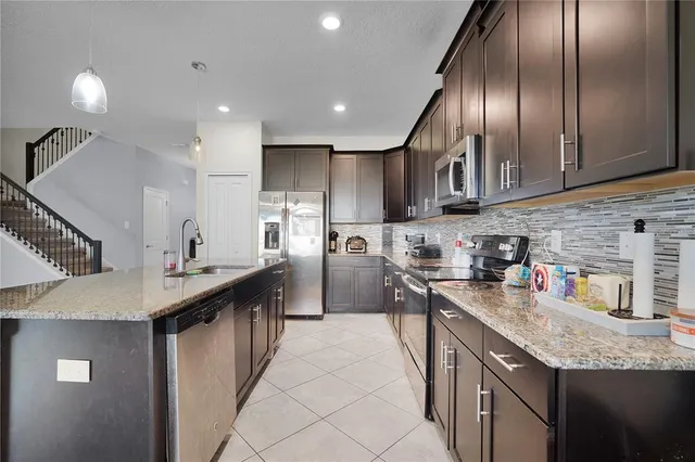 a kitchen with counter top space cabinets and stainless steel appliances