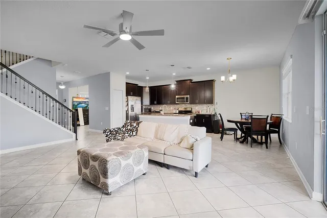 a living room with furniture and kitchen view