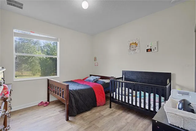 a bed sitting in a bedroom next to a window