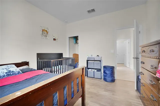 a bedroom with furniture and baby crib