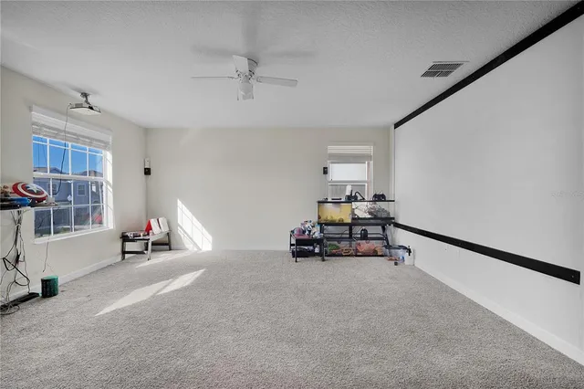 a living room with furniture and a gym machine