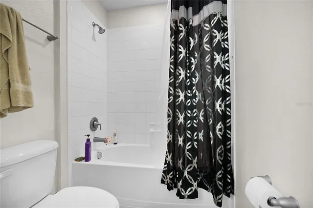 a white toilet sitting next to a bathroom sink