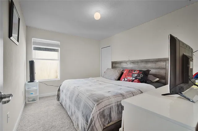 a bedroom with a bed and a tv