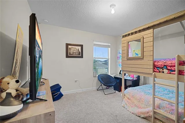 a bedroom with furniture and a large window