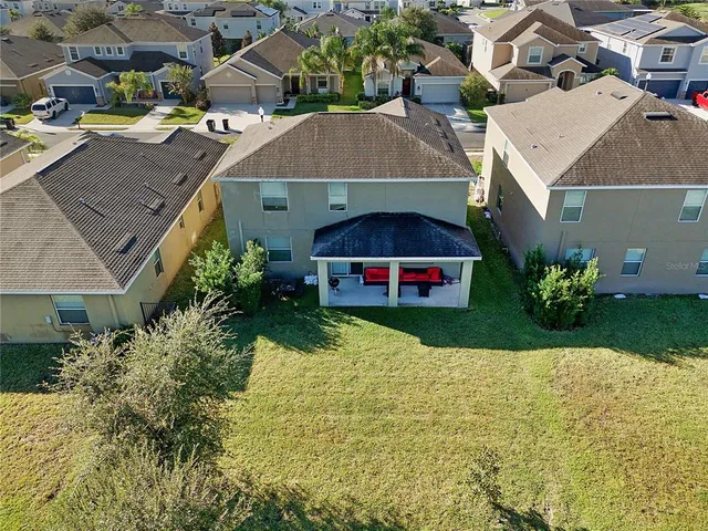 an aerial view of multiple houses with yard