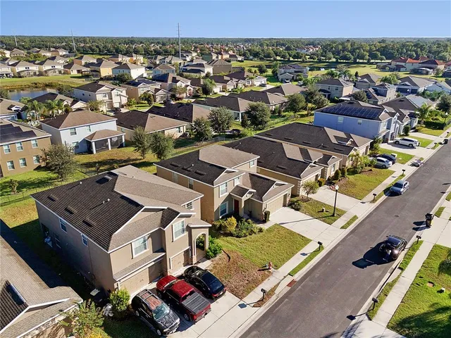 an aerial view of residential houses with outdoor space