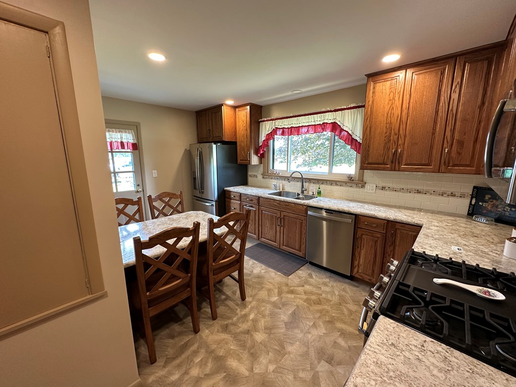 1525 Pittsburgh Road Franklin, PA 16323 - Photo 7 of 31 a kitchen with stainless steel appliances a stove a sink and a refrigerator