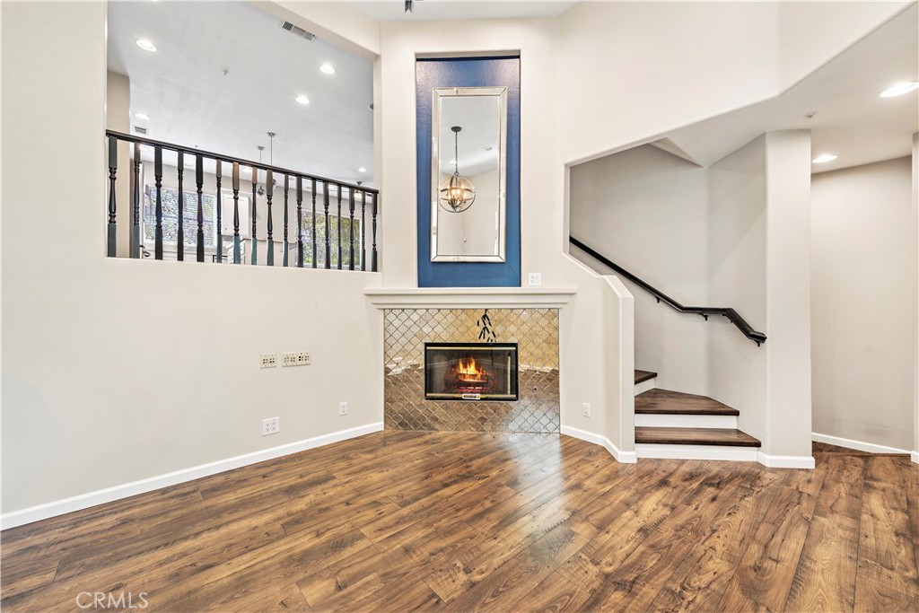 158 North Brea Boulevard Brea, CA 92821 - Photo 7 of 22 a view of staircase and kitchen with fireplace