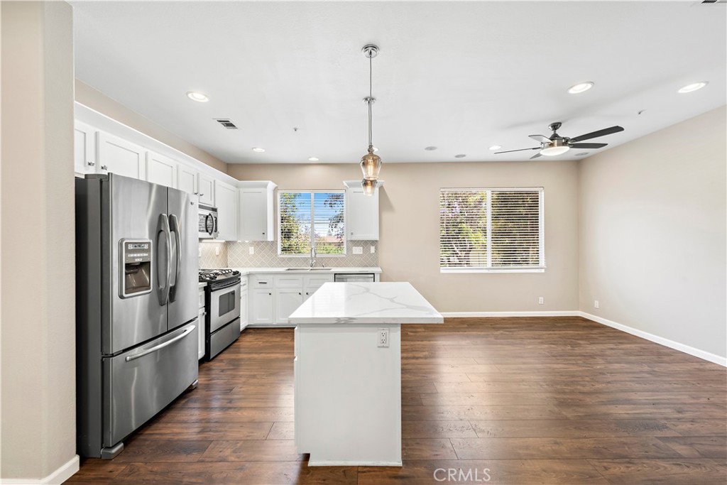 158 North Brea Boulevard Brea, CA 92821 - Photo 10 of 22 a kitchen with kitchen island white cabinets and refrigerator