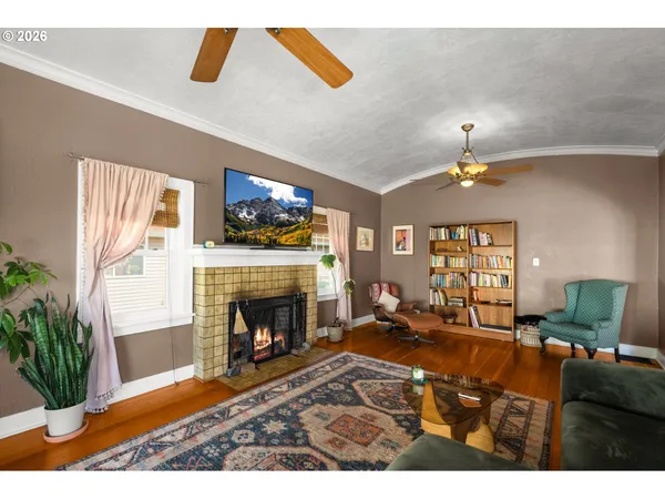 a kitchen with a sink a stove a chimney and a large window