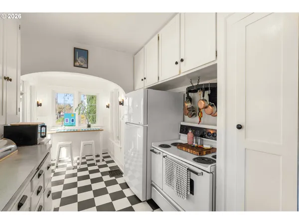 a living room with stainless steel appliances kitchen island granite countertop furniture and a fireplace