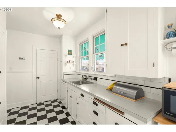 a kitchen with a refrigerator and a stove