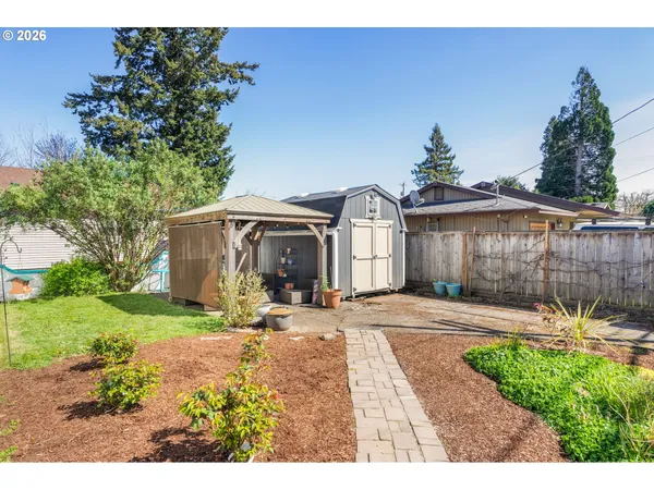 a view of a house with backyard and sitting area