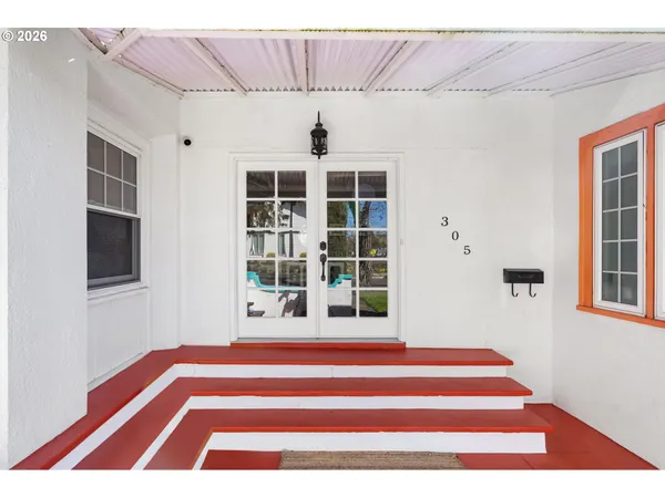 a front view of a house with a floor to ceiling window