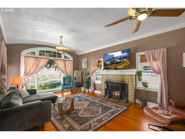 a living room with fireplace furniture and a flat screen tv