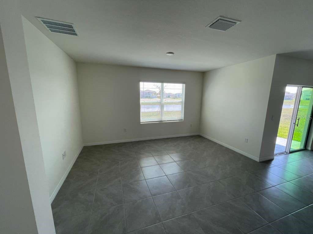 8954 Forge Breeze Loop Wesley Chapel, FL 33545 - Photo 11 of 37 an empty room with windows