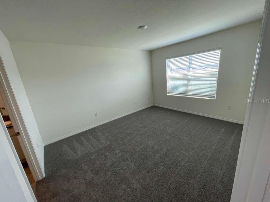 8954 Forge Breeze Loop Wesley Chapel, FL 33545 - Photo 12 of 37 an empty room with a window