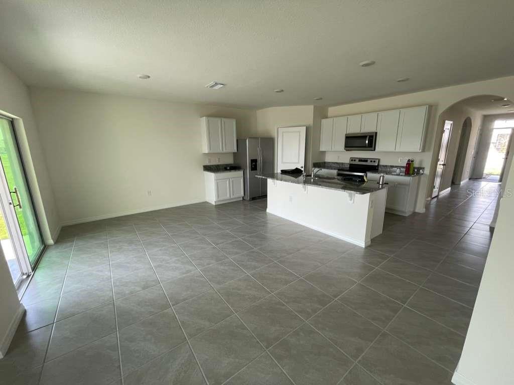 8954 Forge Breeze Loop Wesley Chapel, FL 33545 - Photo 15 of 37 a view of kitchen with sink microwave and cabinets