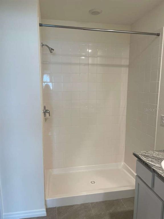 8954 Forge Breeze Loop Wesley Chapel, FL 33545 - Photo 17 of 37 a bathroom with a shower and a bath tub
