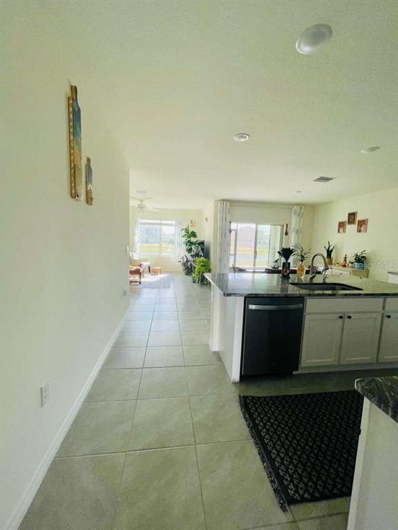 8954 Forge Breeze Loop Wesley Chapel, FL 33545 - Photo 29 of 37 a living room with furniture and a kitchen