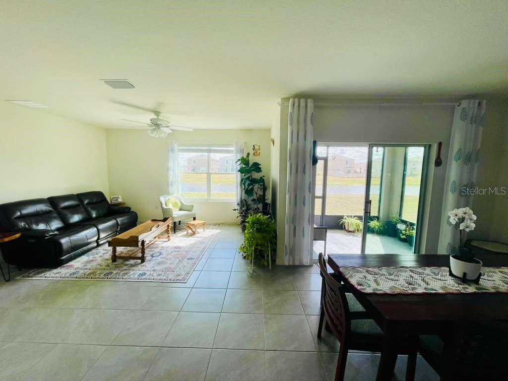 8954 Forge Breeze Loop Wesley Chapel, FL 33545 - Photo 35 of 37 a living room with furniture and wooden floor
