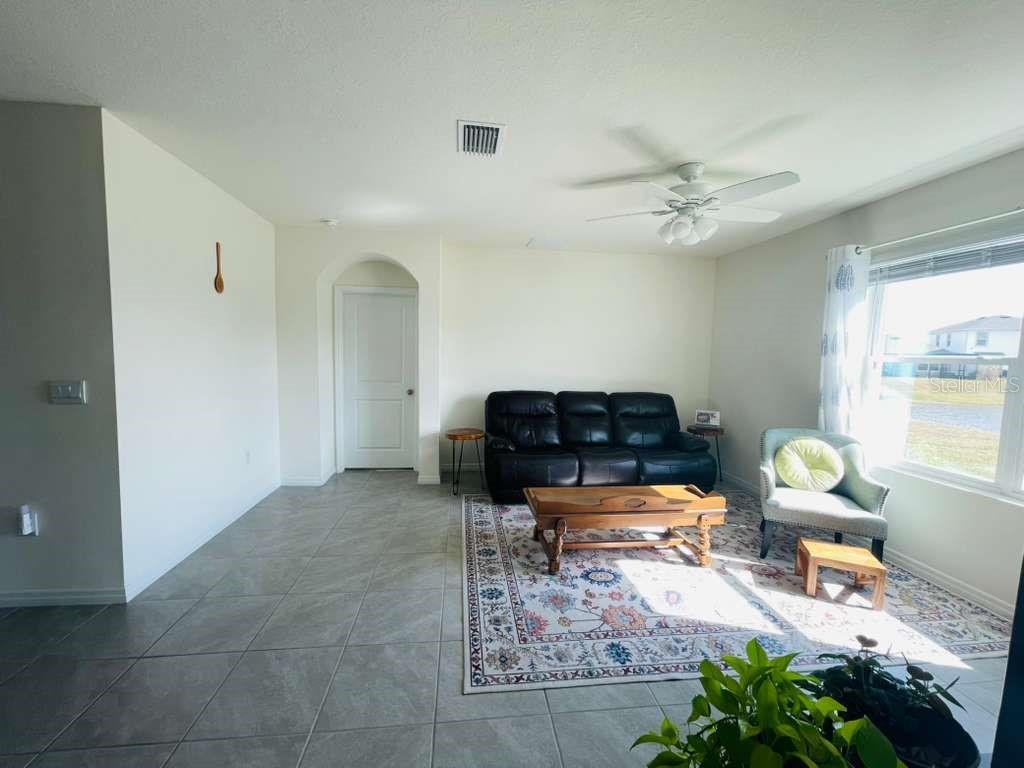 8954 Forge Breeze Loop Wesley Chapel, FL 33545 - Photo 36 of 37 a living room with furniture