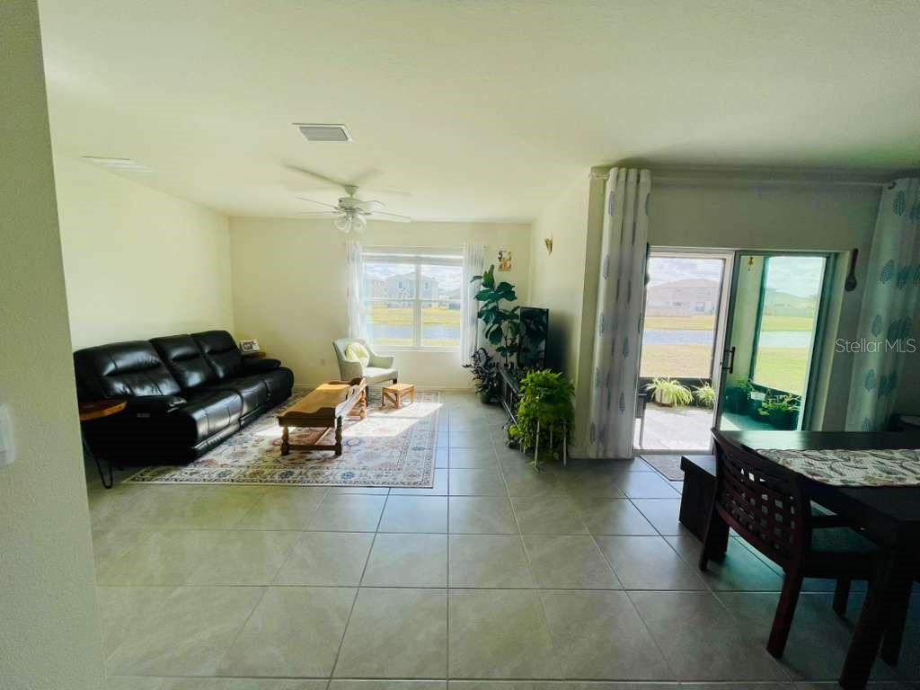 8954 Forge Breeze Loop Wesley Chapel, FL 33545 - Photo 8 of 37 a living room with furniture and a large window