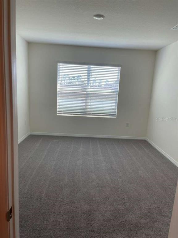 8954 Forge Breeze Loop Wesley Chapel, FL 33545 - Photo 9 of 37 an empty room with a empty space and window