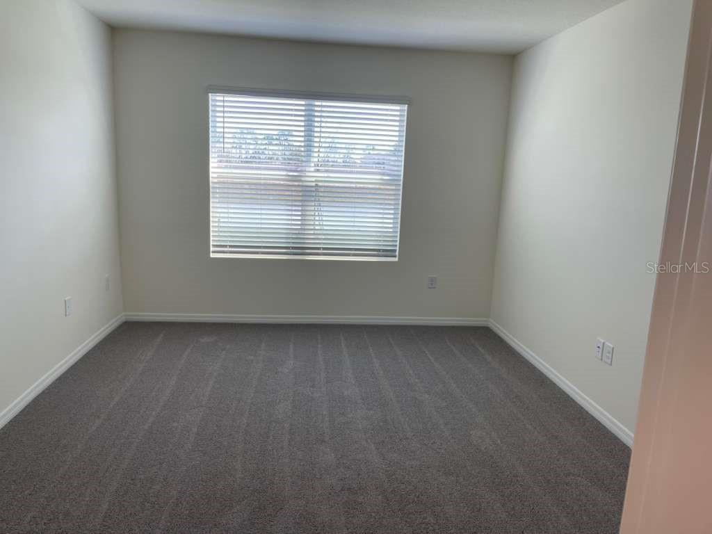8954 Forge Breeze Loop Wesley Chapel, FL 33545 - Photo 10 of 37 an empty room with a window