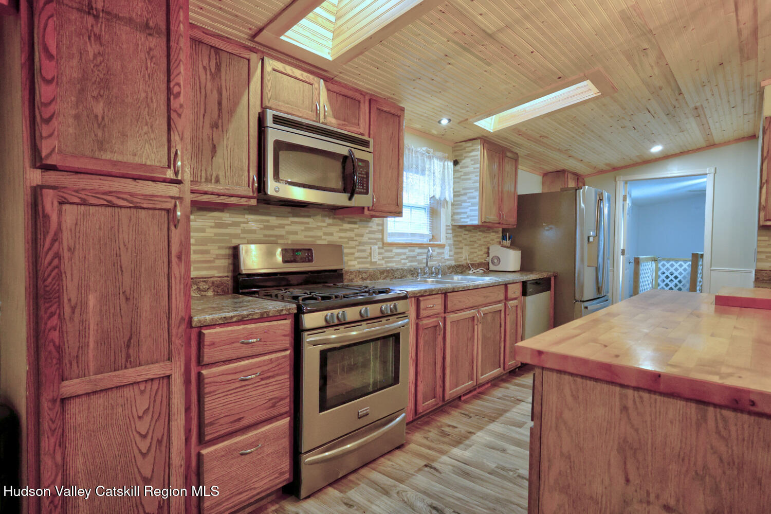 141 Jones Road Round Top, NY 12473 - Photo 14 of 70 a kitchen with stainless steel appliances granite countertop a stove microwave and refrigerator