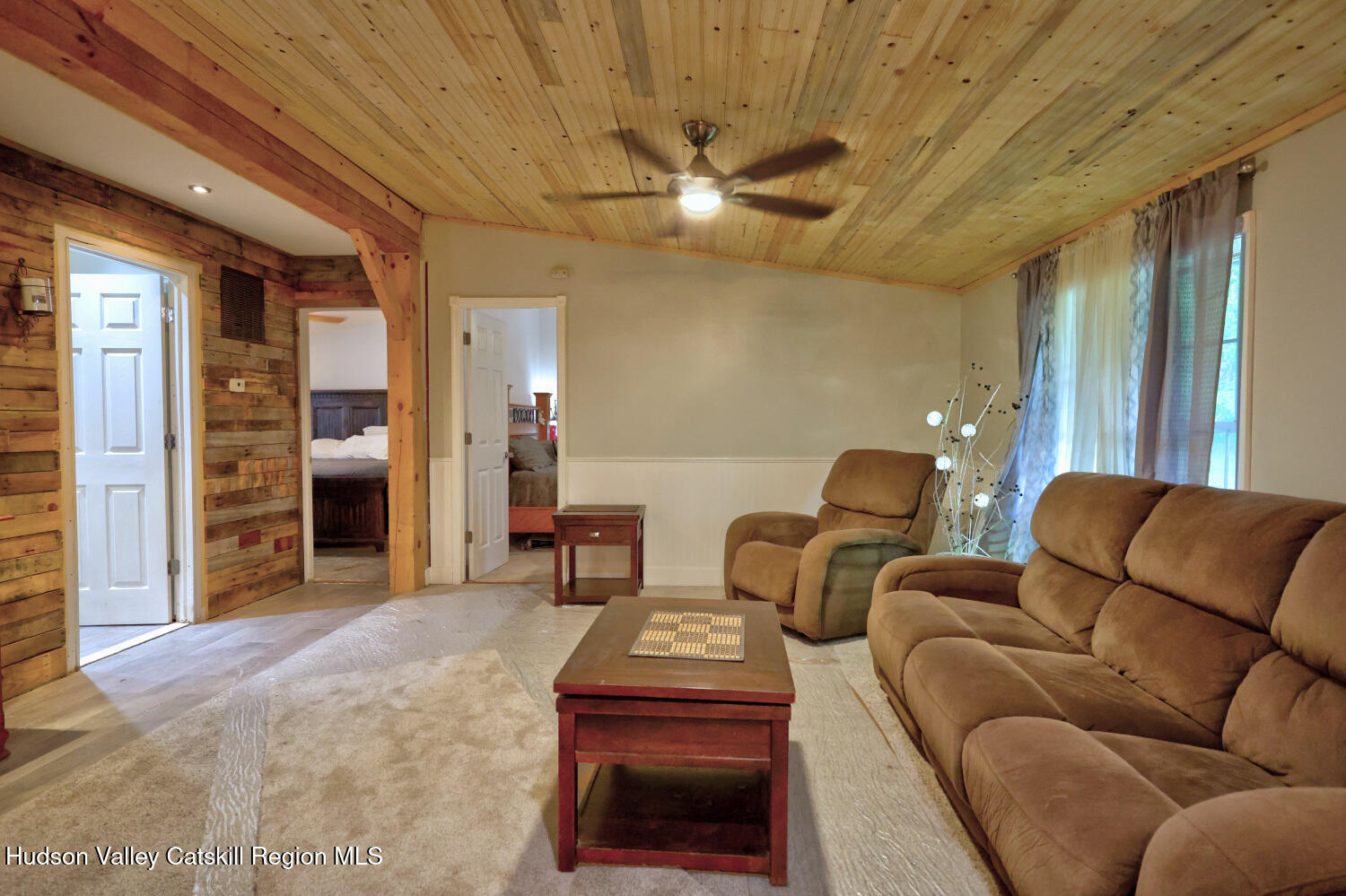 141 Jones Road Round Top, NY 12473 - Photo 23 of 70 a living room with furniture and a chandelier