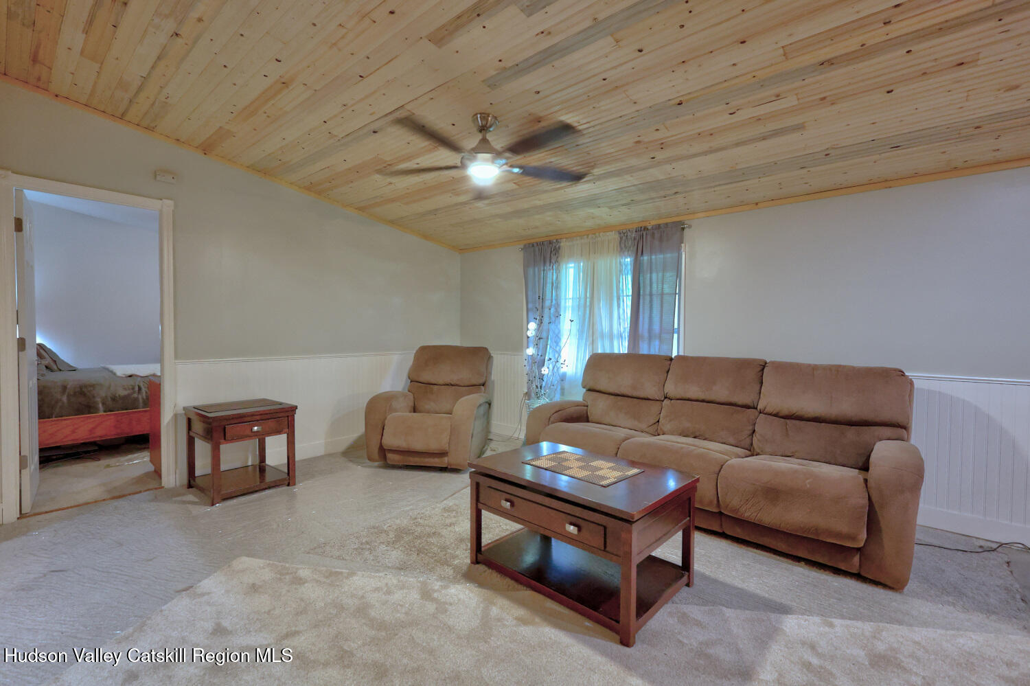 141 Jones Road Round Top, NY 12473 - Photo 24 of 70 a living room with furniture and a chandelier