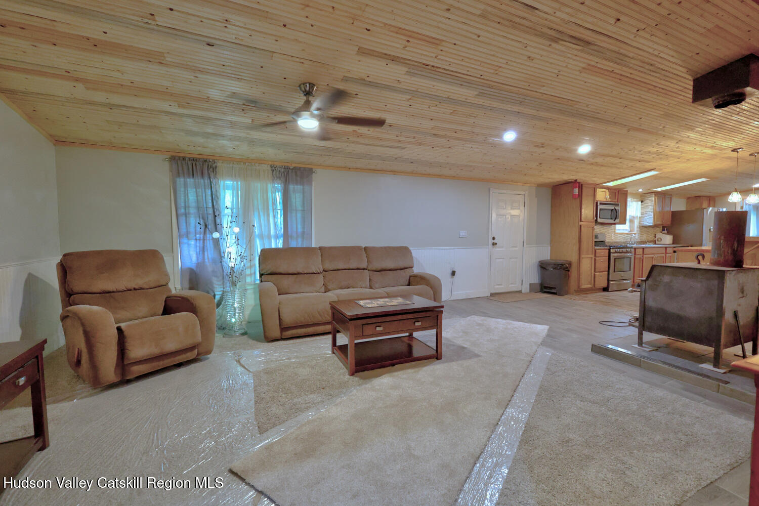 141 Jones Road Round Top, NY 12473 - Photo 26 of 70 a living room with furniture ceiling fan and a rug